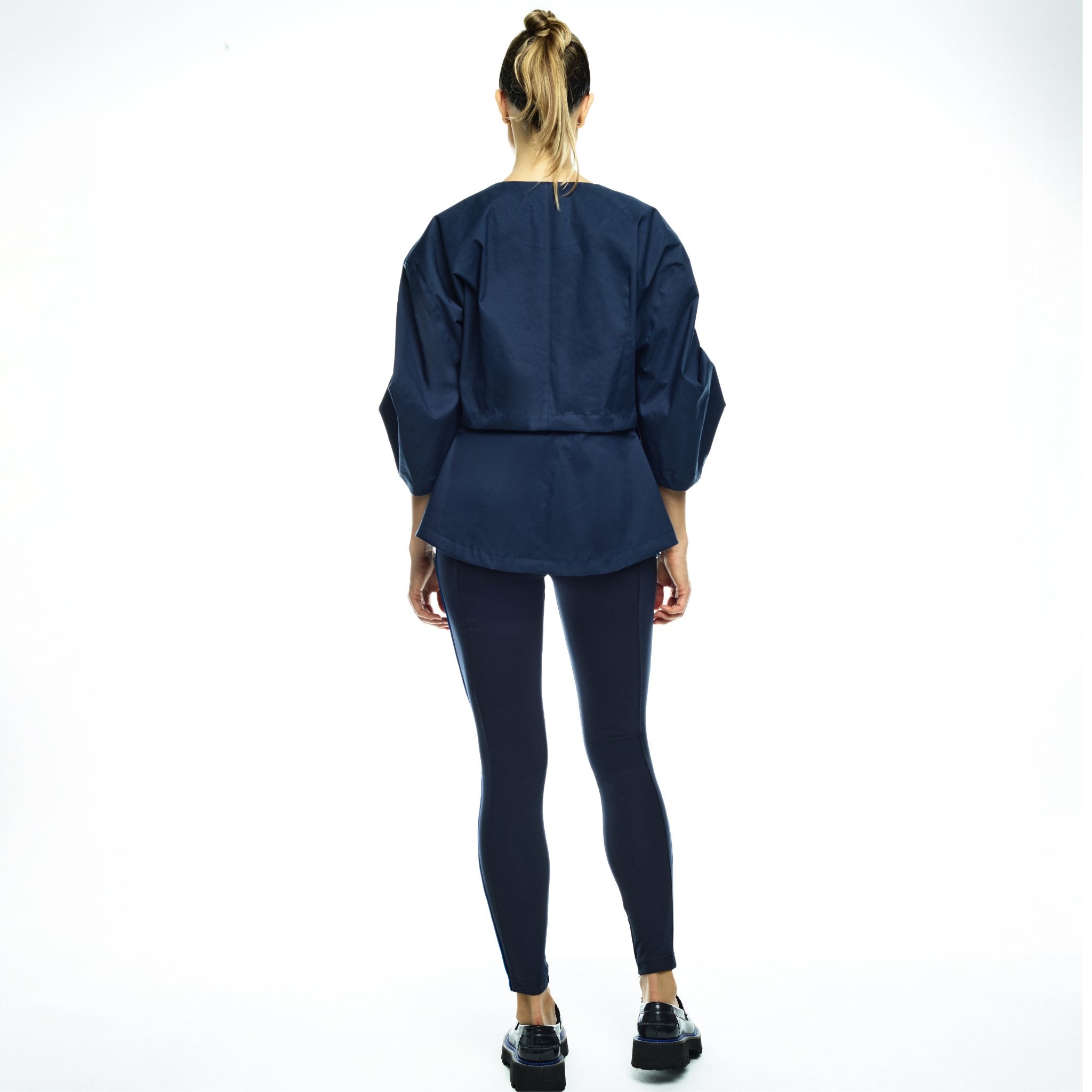 Person wearing a navy blue outfit on a white background