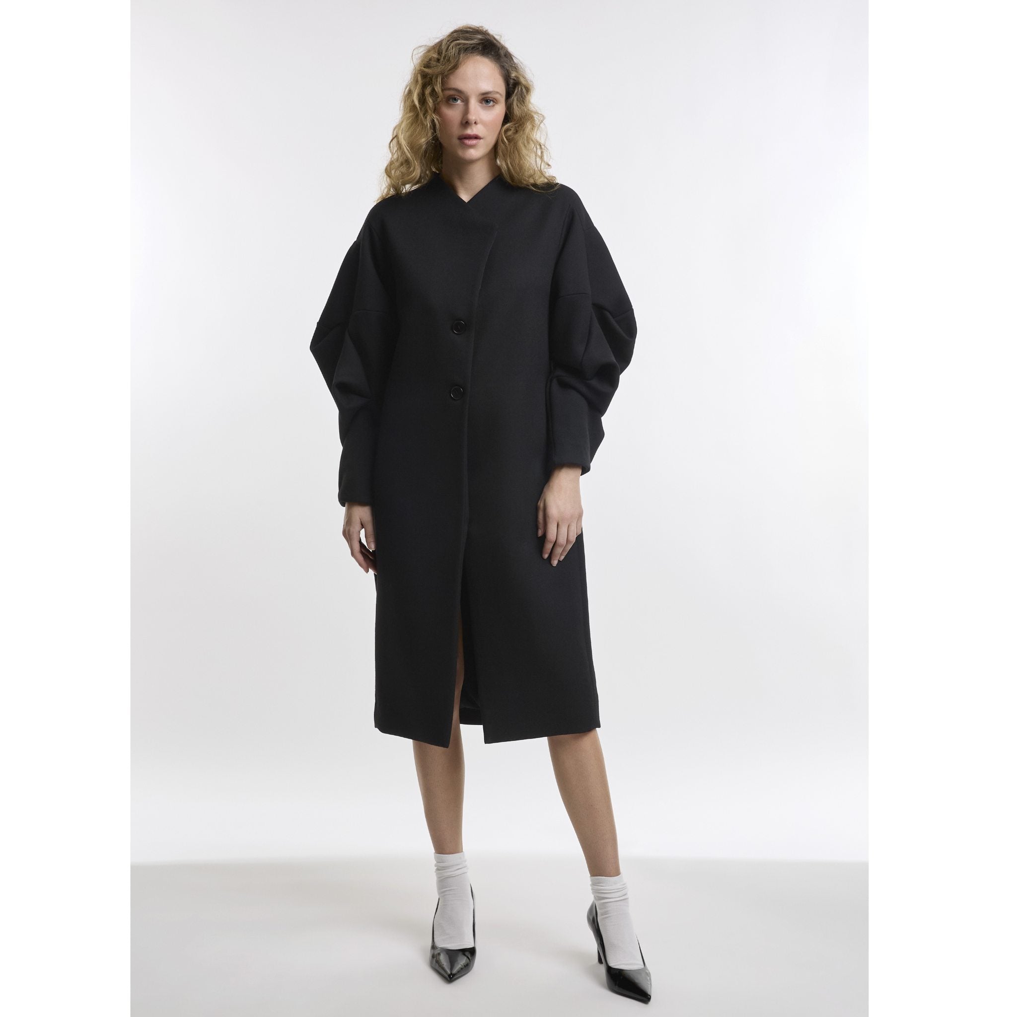 Woman wearing black coat white background