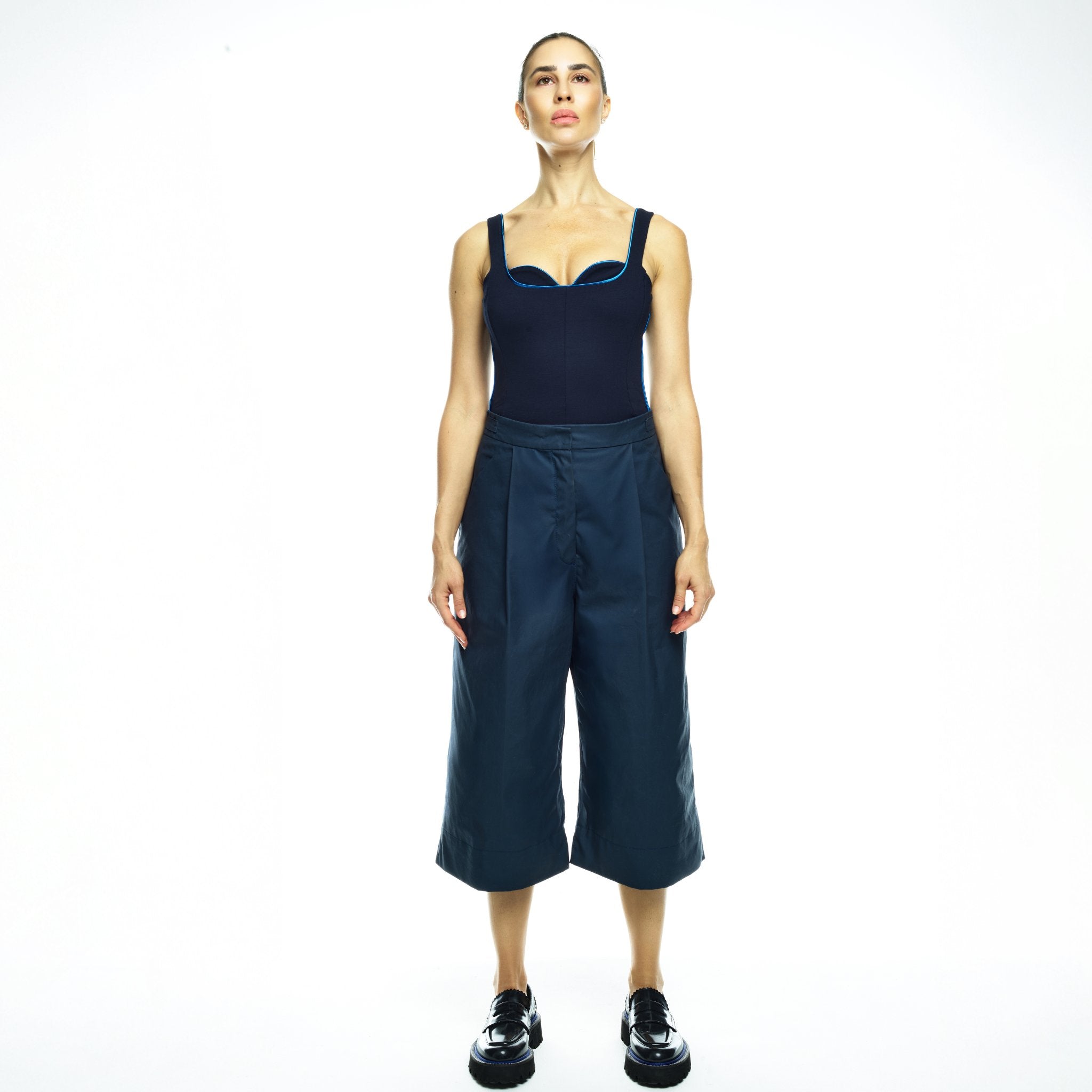 Woman wearing navy outfit on white background
