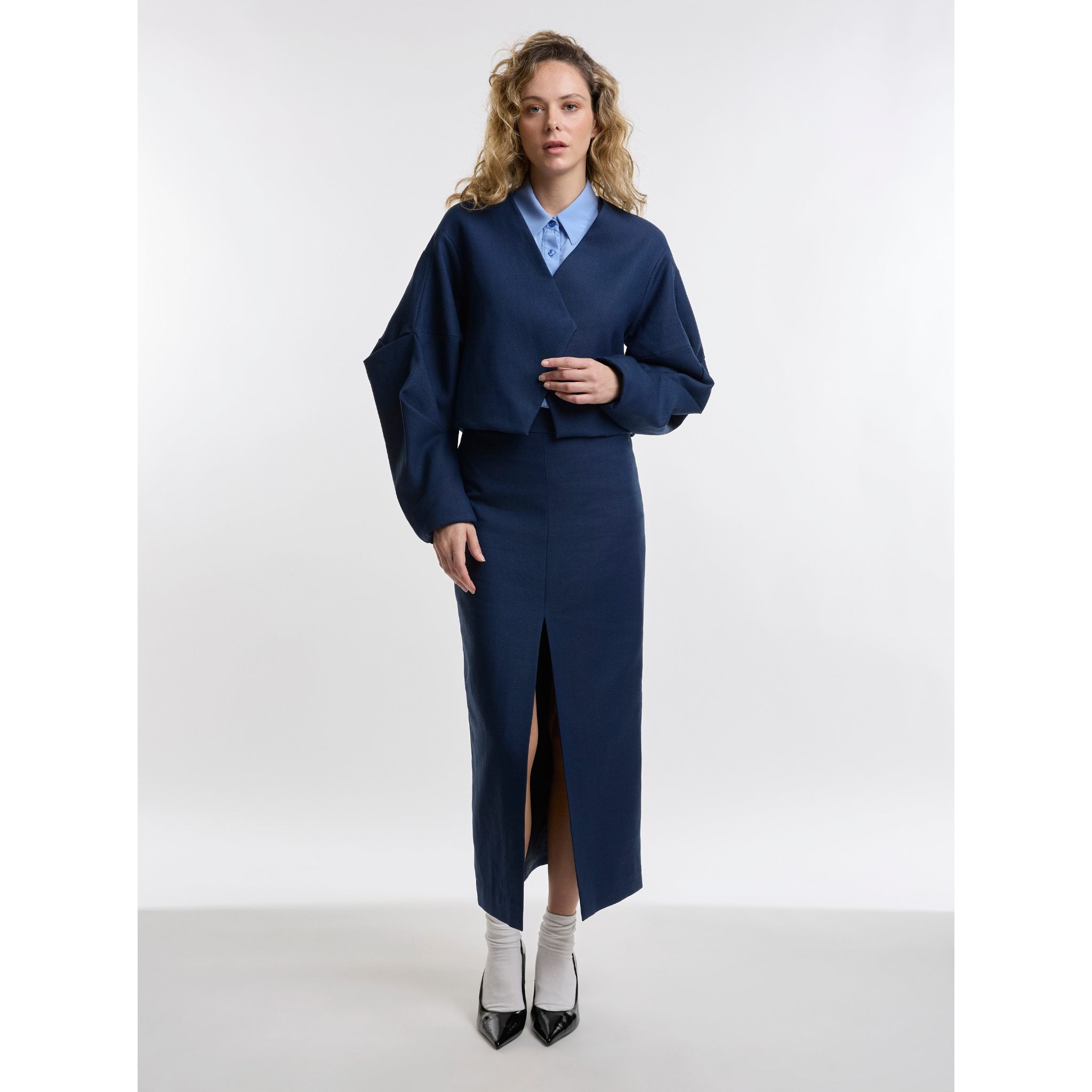Woman wearing navy pencil skirt and jacket