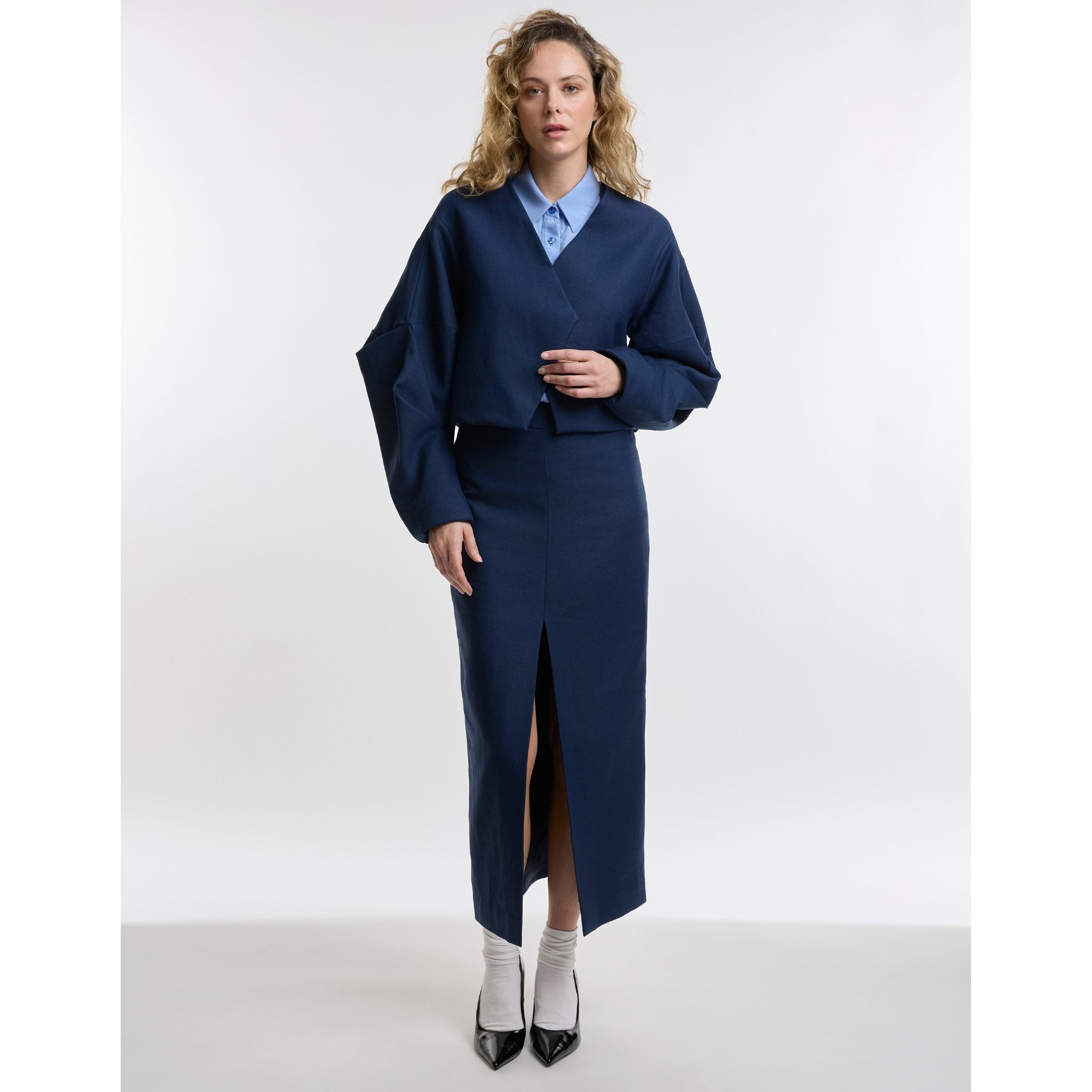 Woman wearng a navy outfit on white background