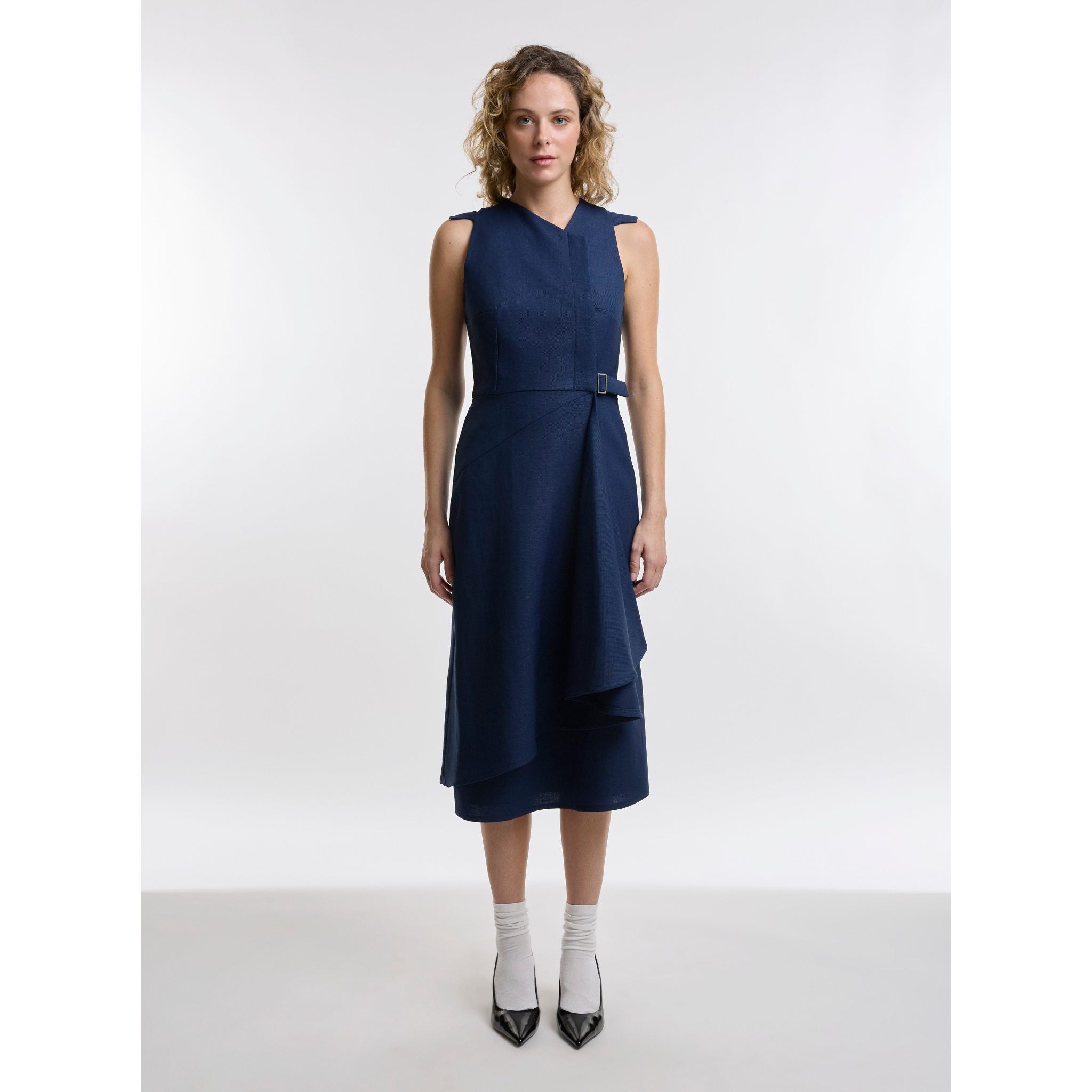 Woman wearing a navy blue dress on a white background
