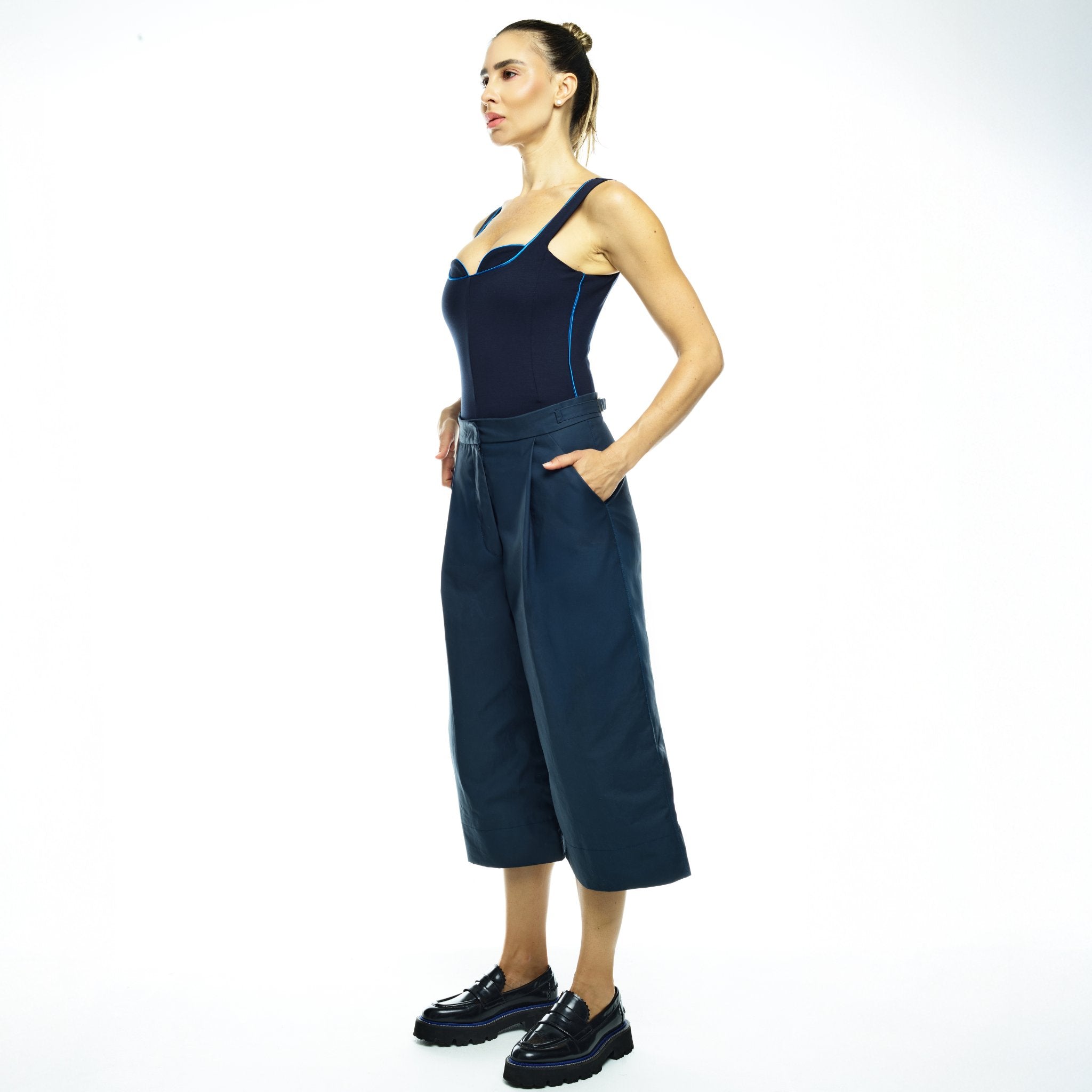 Woman wearing navy outfit with white background