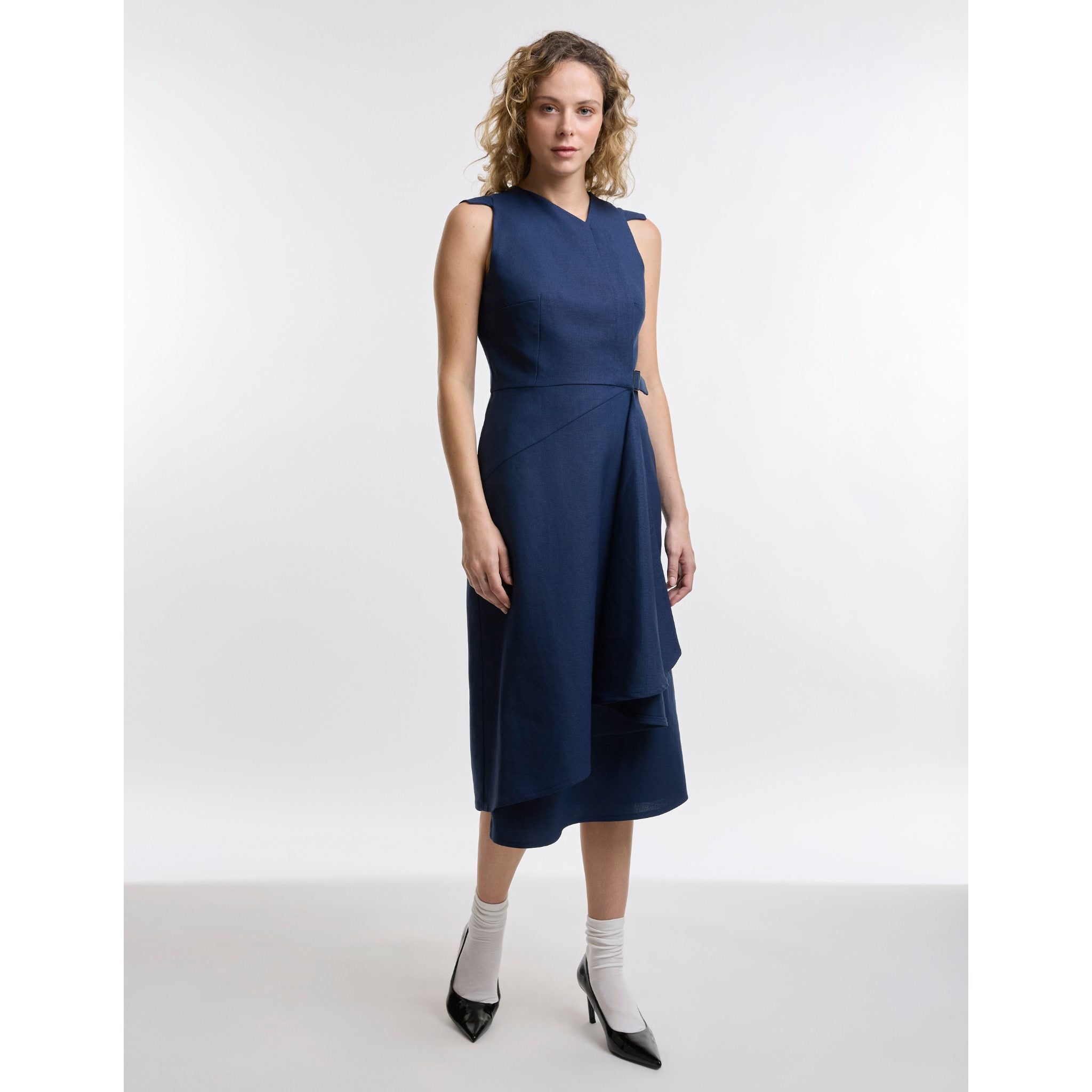 Woman wearing a navy blue dress on a white background